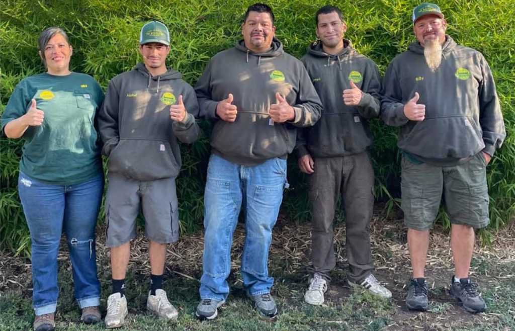 The Recyclers crew standing together and giving a thumbs-up