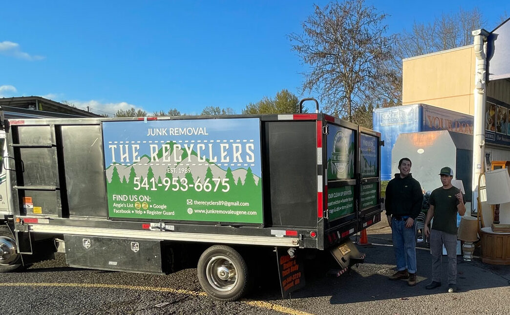 The Recyclers crew unloading furniture and lamps from their truck at the Goodwill Donation Center